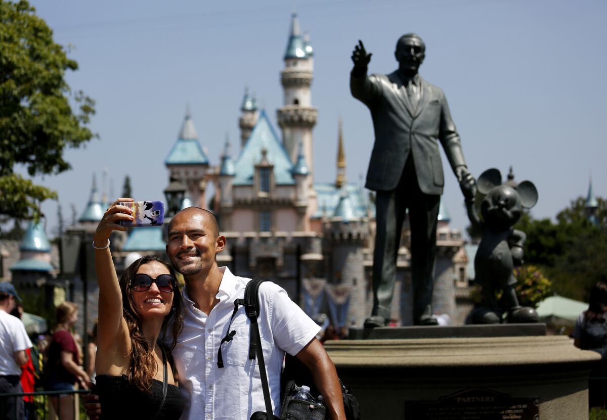 A couple takes a selfie at Disneyland