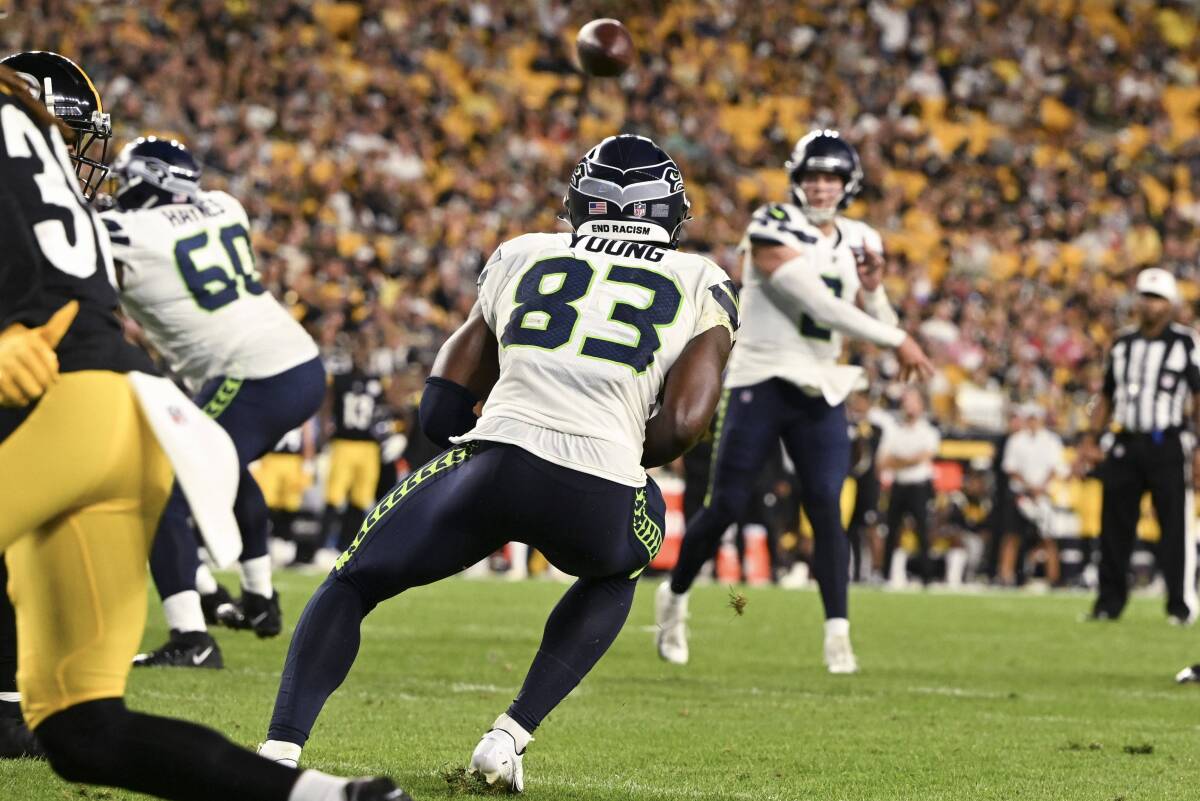 Seattle Seahawks quarterback Drew Lock, rear, throws a touchdown pass to wide receiver Dareke Young (83) against the Pittsburgh Steelers during the second half of an NFL preseason football game Saturday, Aug. 13, 2022, in Pittsburgh. (AP Photo/Barry Reeger)