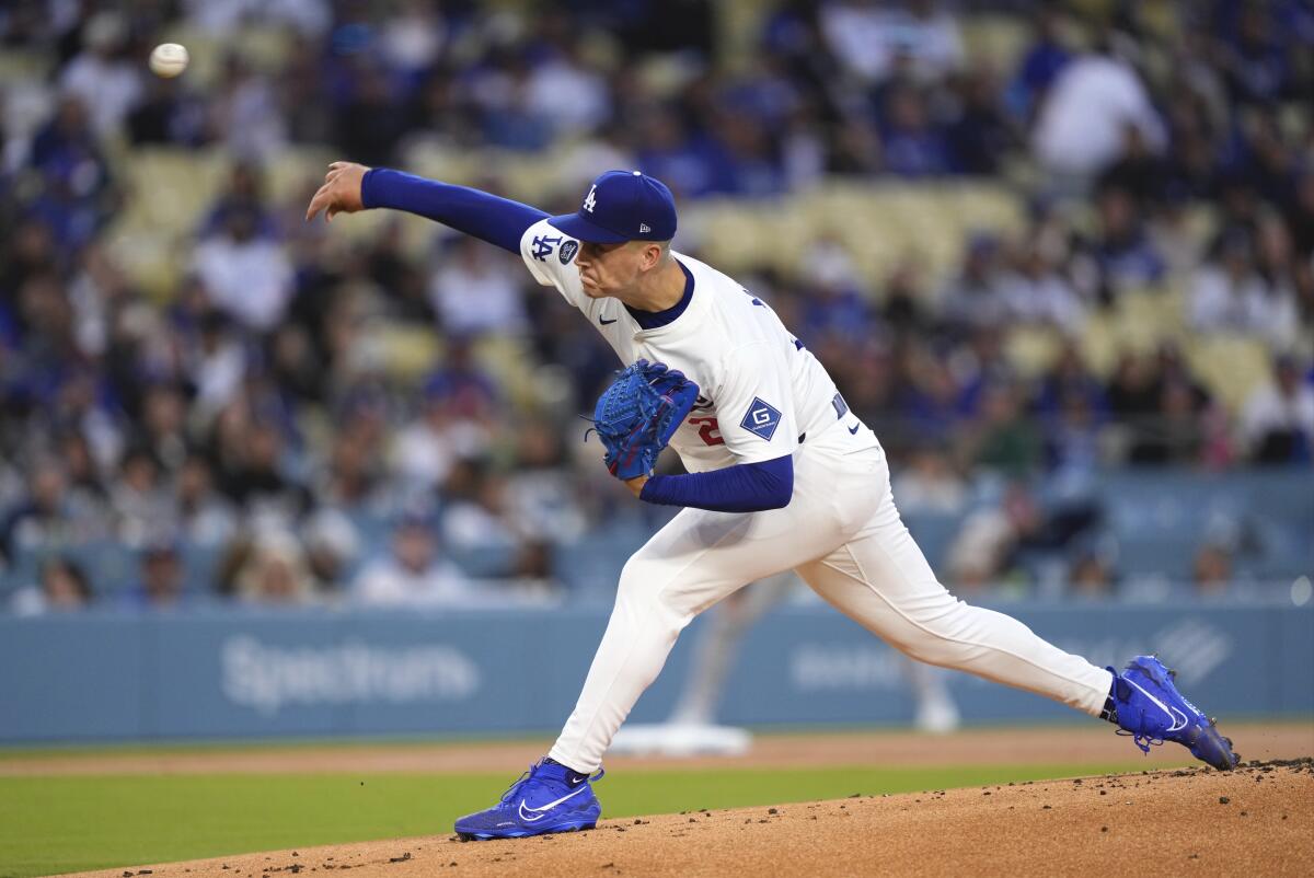 Los Angeles Dodgers starting pitcher Bobby Miller throws in the first inning.