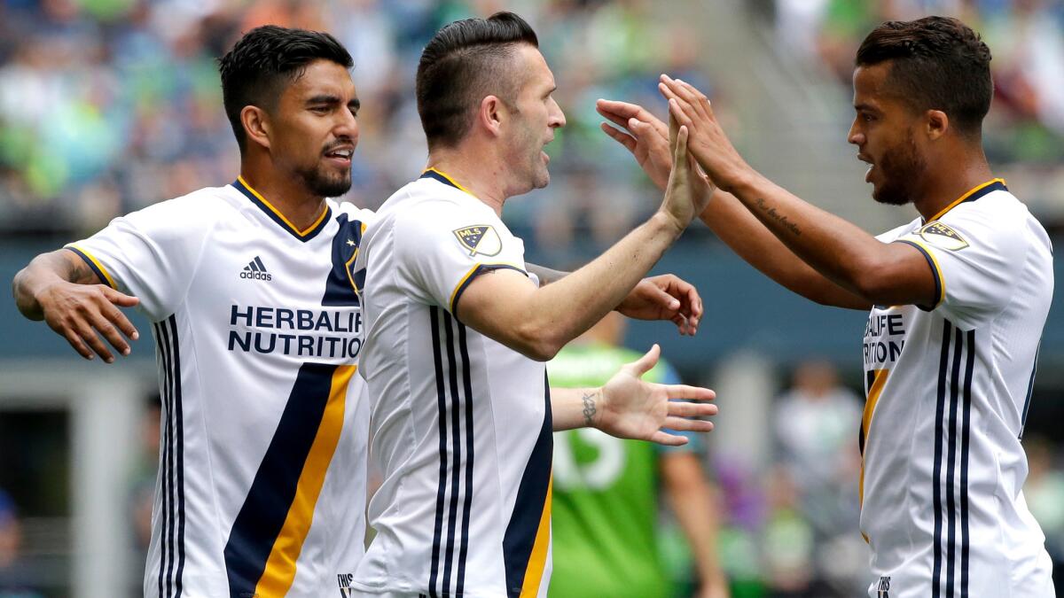 Forward Robbie Keane, center, is congratulated by teammates Giovani dos Santos, right, and A.J. DeLaGarza after scoring the only goal in the Galaxy's win over the Sounders on July 9.