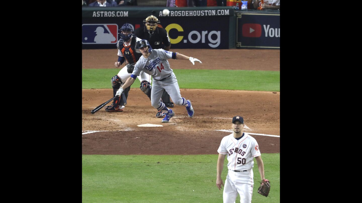 The Dodgers' Enrique Hernandez and Astros pitcher Charlie Morton watch the ball sail into right center field for a sixth-inning hit.