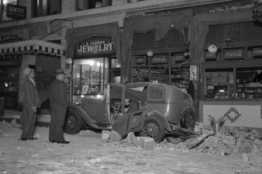 A damaged building and an automobile on Beacon Street 