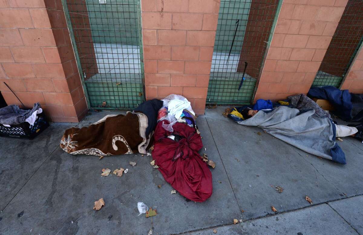 Homeless people sleep on skid row in Los Angeles.