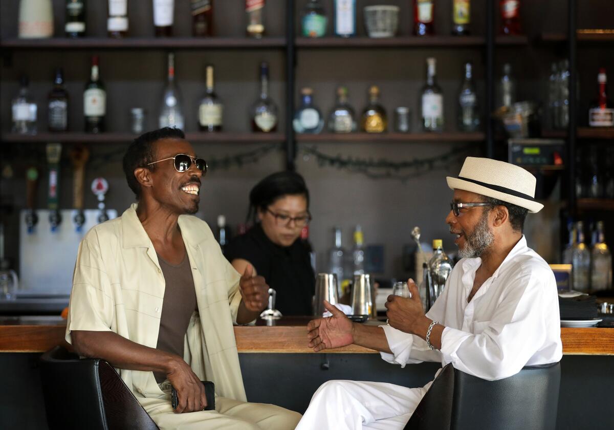 Brad Patterson, left, and Reggie Dunn chat in the bar at Post & Beam 