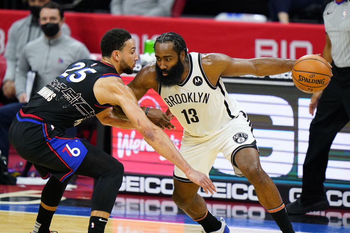FILE - Brooklyn Nets' James Harden (13) tries to drive past Philadelphia 76ers' Ben Simmons (25) during the second half of an NBA basketball game, Saturday, Feb. 6, 2021, in Philadelphia. The Philadelphia 76ers have traded Ben Simmons to the Brooklyn Nets for James Harden as part of a multiplayer deal. The trade was confirmed by multiple people who spoke to The Associated Press Thursday, Feb. 10, 2022, on condition of anonymity because the trade had not been announced. (AP Photo/Matt Slocum, File)