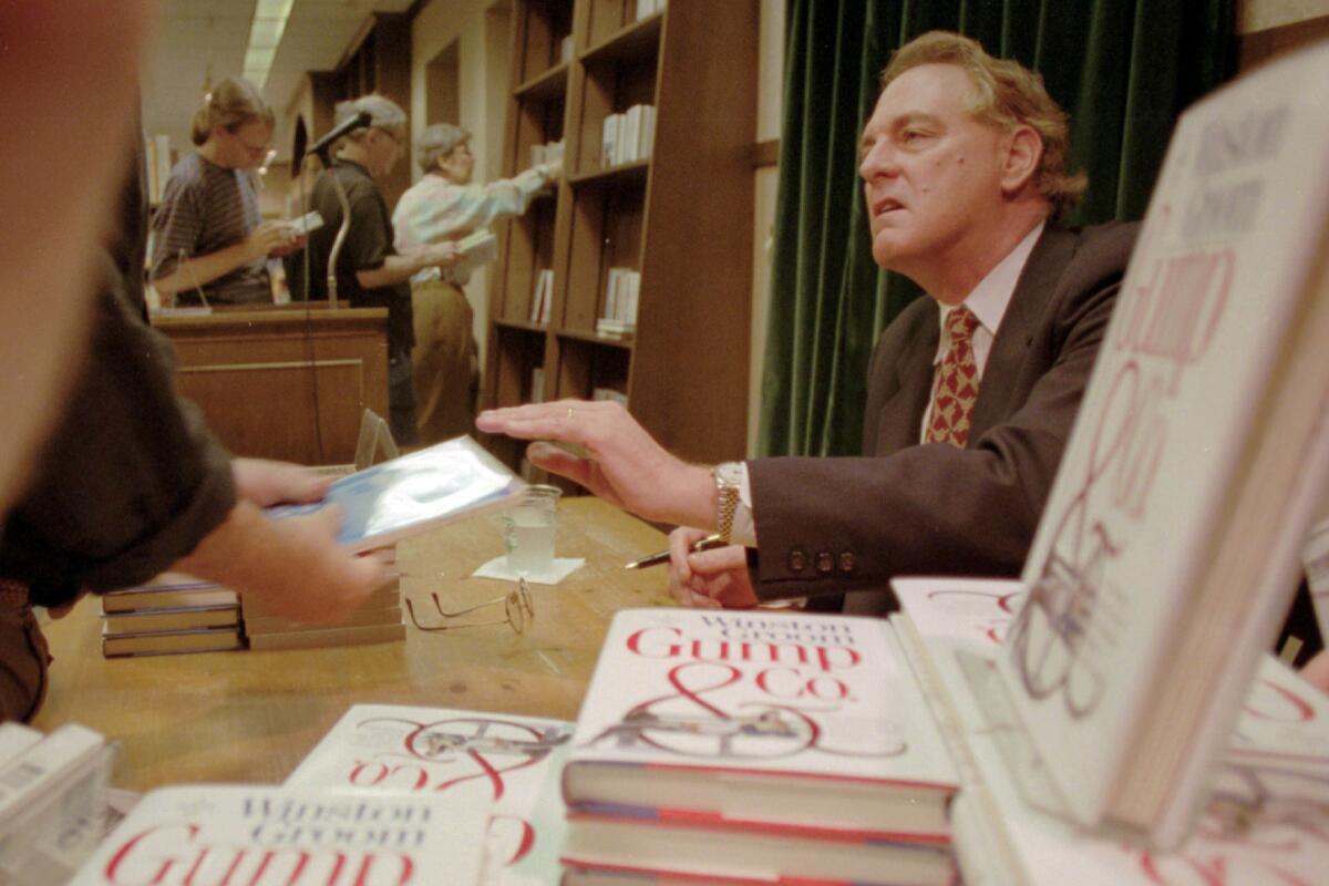  Winston Groom signs copies of "Gump & Co.," the sequel to "Forrest Gump", at a New York City bookstore in 1995. 