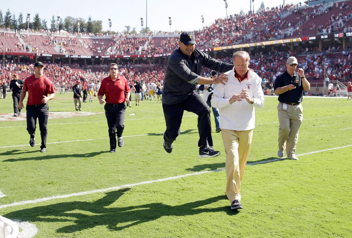 USC Coach Steve Sarkisian jumps in celebration next to Athletic Director Pat Haden after the Trojans beat Stanford on Sept. 6 in Palo Alto.