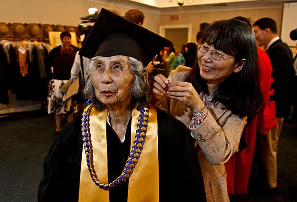 Michiko Doihara Tamaki, left, gets help from her daughter, Jeanne Tamaki, as she prepares for a special ceremony to receive an honorary degree.