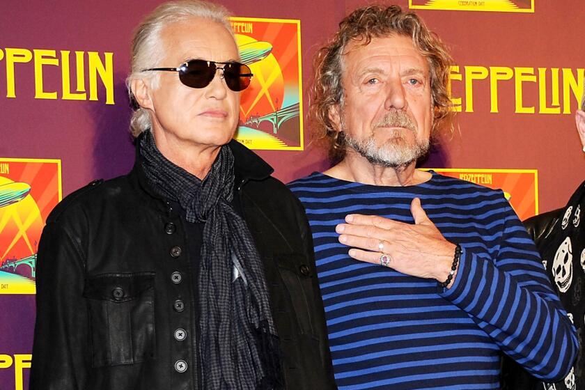 In this Oct. 9, 2012, file photo, Led Zeppelin guitarist Jimmy Page, left, and singer Robert Plant appear at a news conference. A federal judge in Los Angeles ruled Friday, April 8, 2016, that a copyright infringement lawsuit over the song "Stairway to Heaven" should be decided at trial.