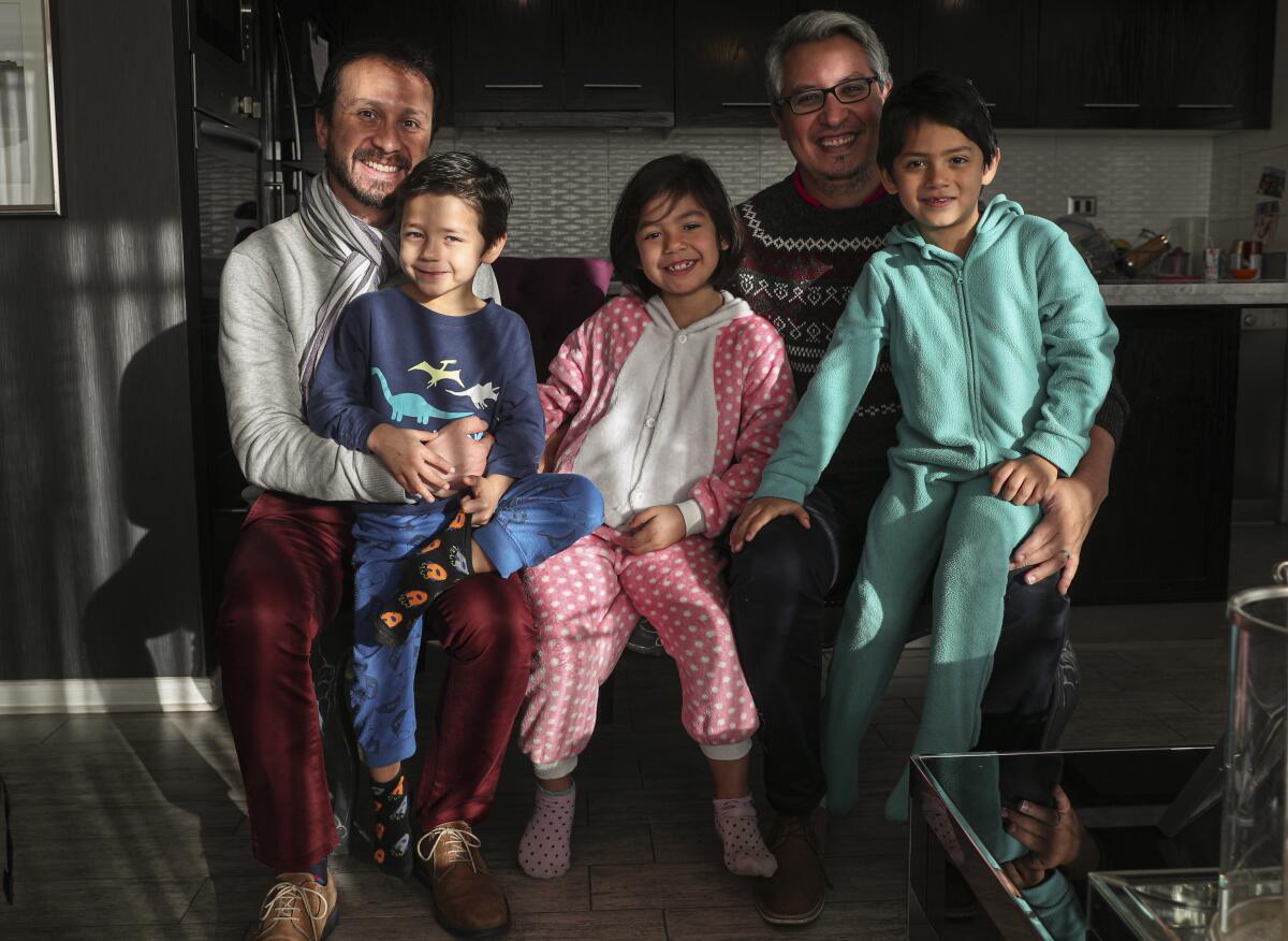 A same-sex couple with their children