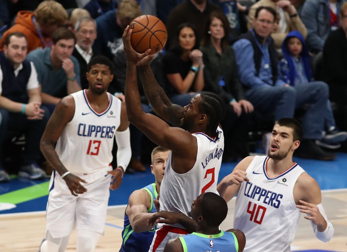 Clippers forward Kawhi Leonard puts up a shot during a 114-99 victory over the Dallas Mavericks on Tuesday.