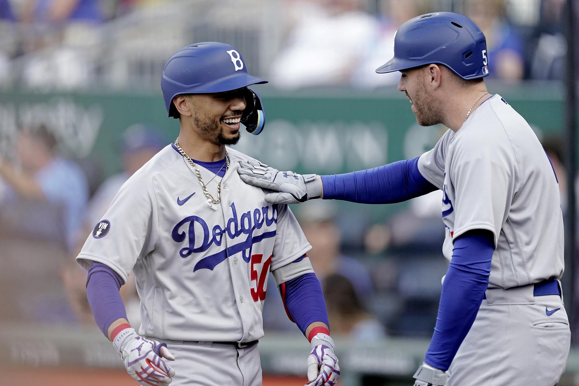 Los Angeles Dodgers' Mookie Betts, left, celebrates with Freddie Freeman after hitting a solo home run.