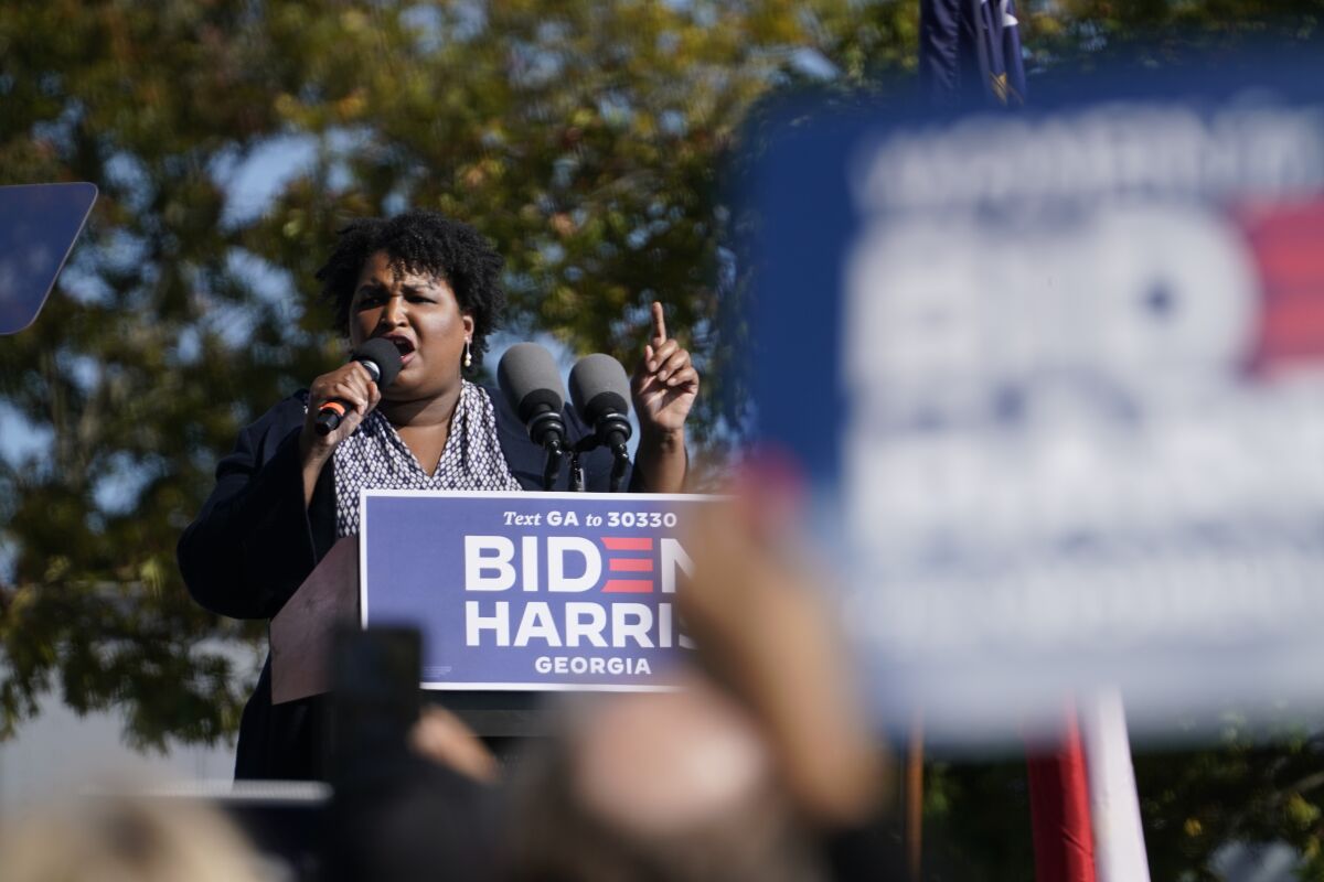 Stacey Abrams speaks to supporters as they wait for former President Barack Obama to arrive and speak at a campaign rally.