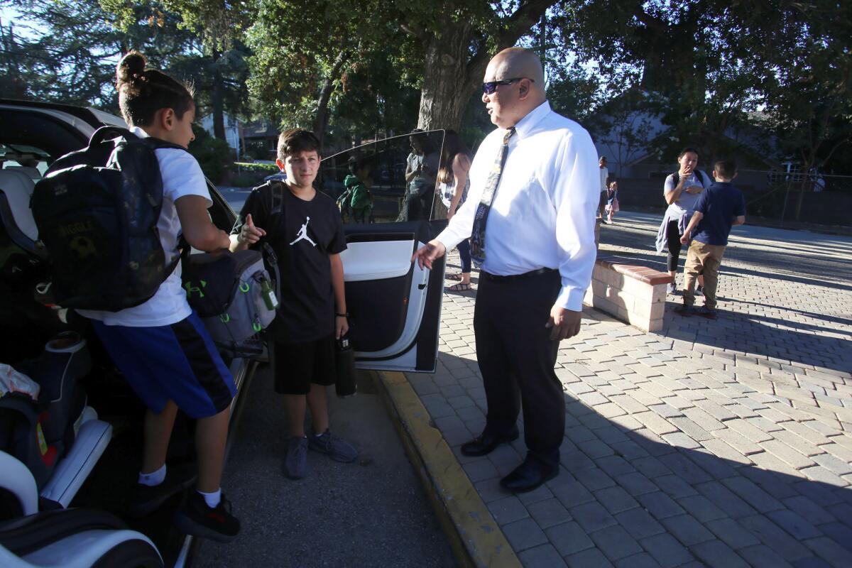 Palm Crest Elementary School Principal Cory Park welcomes his students on the first day of the school year at Palm Crest Elementary School on Aug. 15.