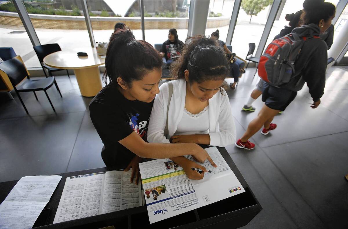 Luz Portillo, 21, left, helps her 14-year-old sister, Jocelyn Portillo, who goes to high school, register for a college-level Spanish I course at Harbor College. They learned the class was already full but hoped to crash it.
