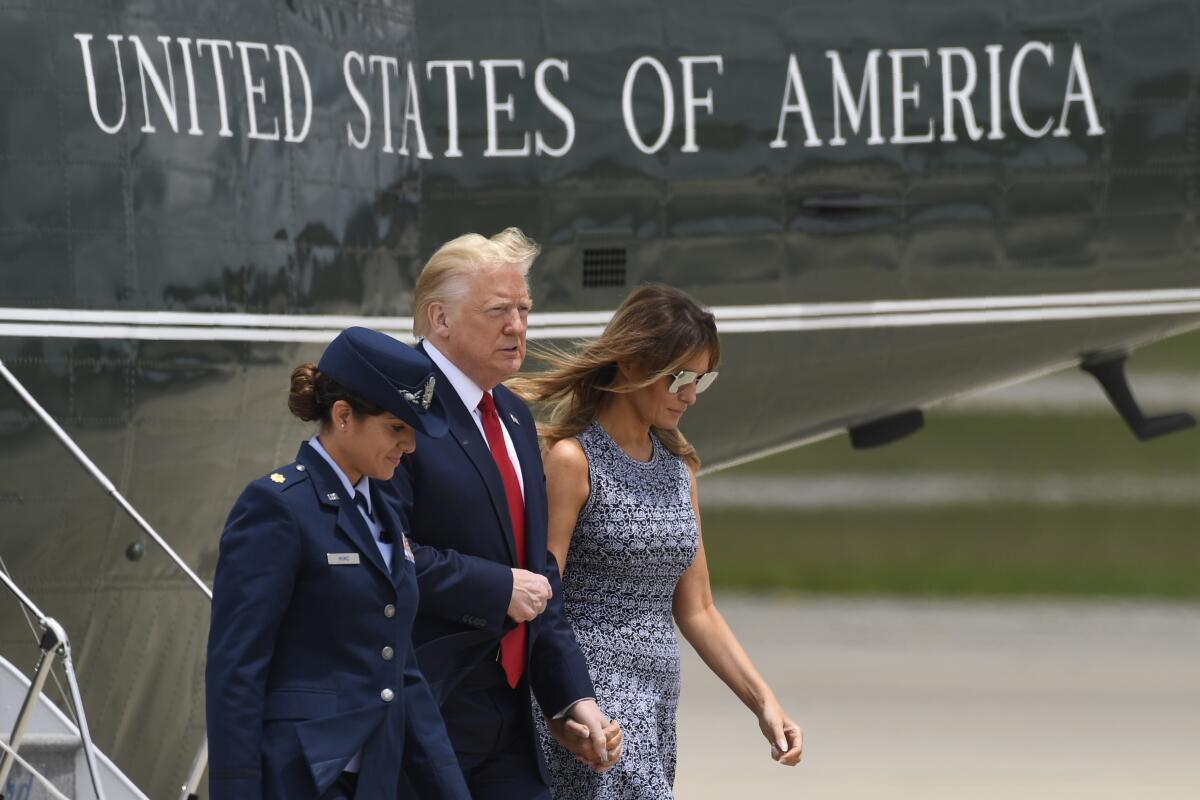 Donald and Melania Trump walk to Air Force One for a trip to attend the SpaceX Demonstration Mission 2 Launch on Wednesday.
