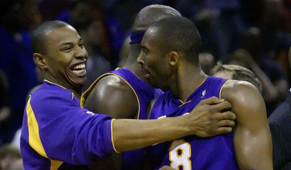 Kobe Bryant is congratulated by Caron Butler, left, and Jumaine Jones, center, after his game–winning basket in the Lakers' 117–116 win over the Charlotte Bobcats on March 12, 2005.