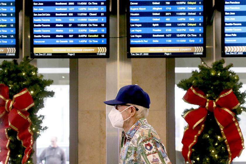 SANTA ANA, CALIF. - DEC. 27, 2022. Arrivals and departures monitors at the Southwest Airlines terminal in John Wayne Airport show many flight delays and cancelations on Tuesday, Dec. 27, 2022. Southwest Airlines has canceled thousands of flights over the Christmas holidays . (Luis Sinco / Los Angeles Times)