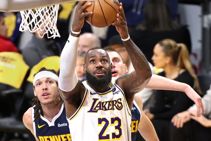 LOS ANGELES, CALIFORNIA - APRIL 27: Lakers LeBron James drives past Nuggets Aaron Gordon.