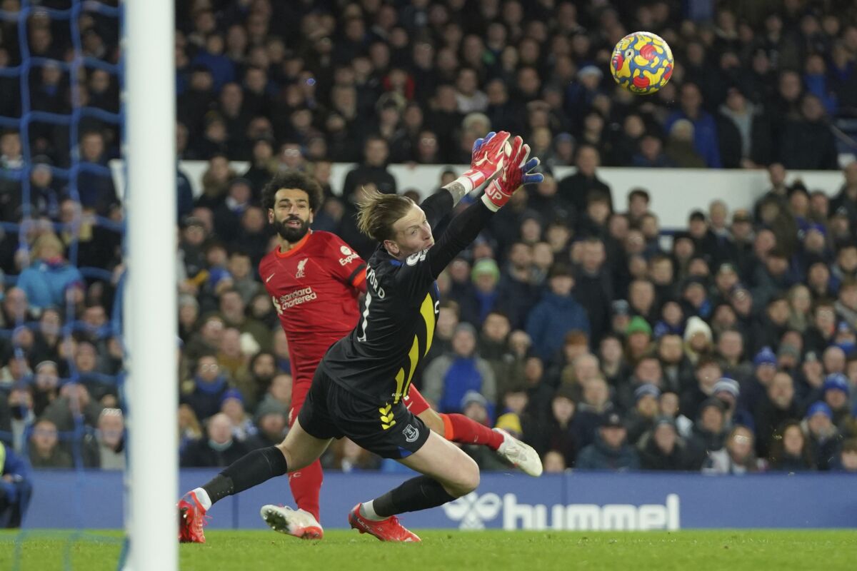 Liverpool's Mohamed Salah, left, scores past Everton's goalkeeper Jordan Pickford his side's second goal during the English Premier League soccer match between Everton and Liverpool at Goodison Park in Liverpool, England, Wednesday, Dec. 1, 2021. (AP Photo/Jon Super)