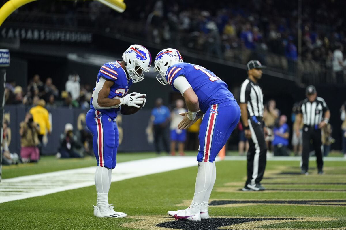 Buffalo Bills running back Matt Breida (22)celebrates his touchdown reception with quarterback Josh Allen, right, in the second half of an NFL football game against the New Orleans Saints in New Orleans, Thursday, Nov. 25, 2021. (AP Photo/Derick Hingle)