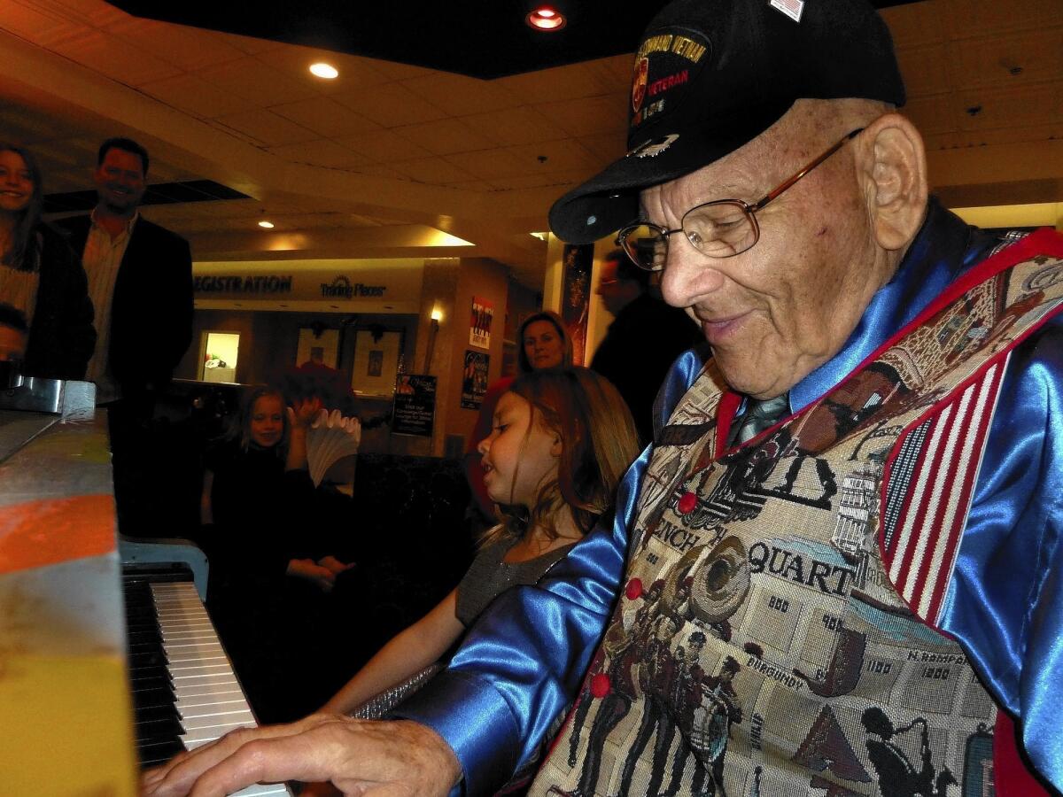 LA-NA-PIANO-MAN-TWO: Joe Vento plays piano in the lobby of an off-the-strip hotel. People stop in and sit next to the old man and sing songs. They listen to his stories. Joe says he turned 95 a few weeks back, but he keeps going because if he doesn't he says, he'll die. Here, 5-year-old Gigi Malandra sits next to the old maestro and blets out a rendition of "Somewhere Over the Rainbow." ( John Glionna / Los Angeles Times )