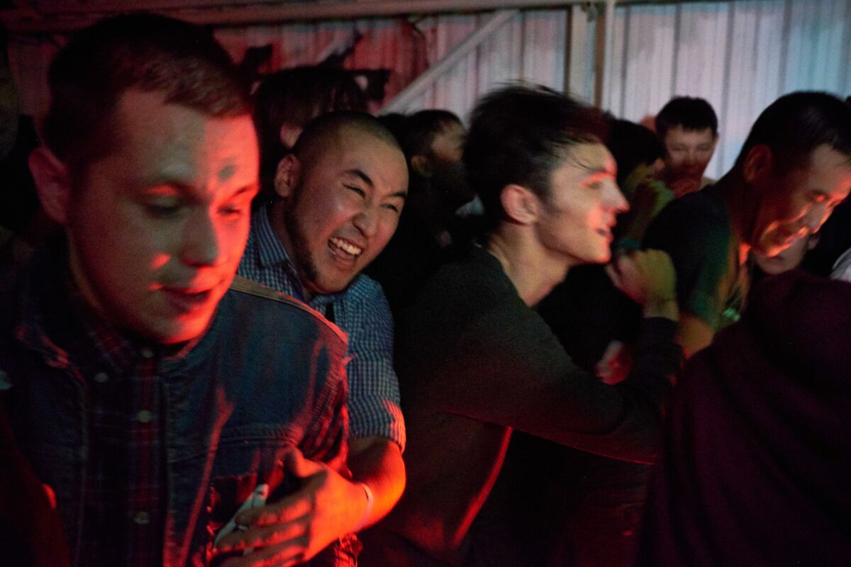 Fans dance in a mosh pit during a concert at the Grunge Bar in Yakutsk.