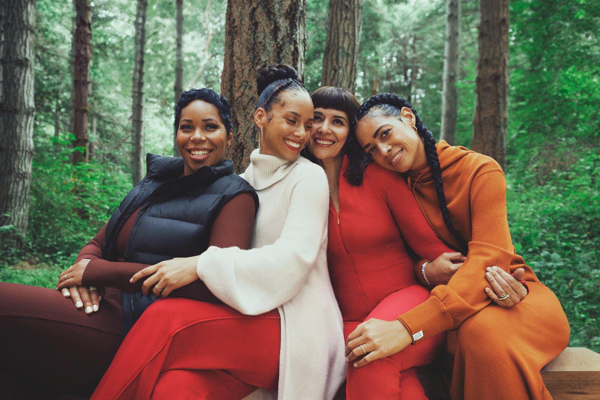 Four women wear rustic colors.