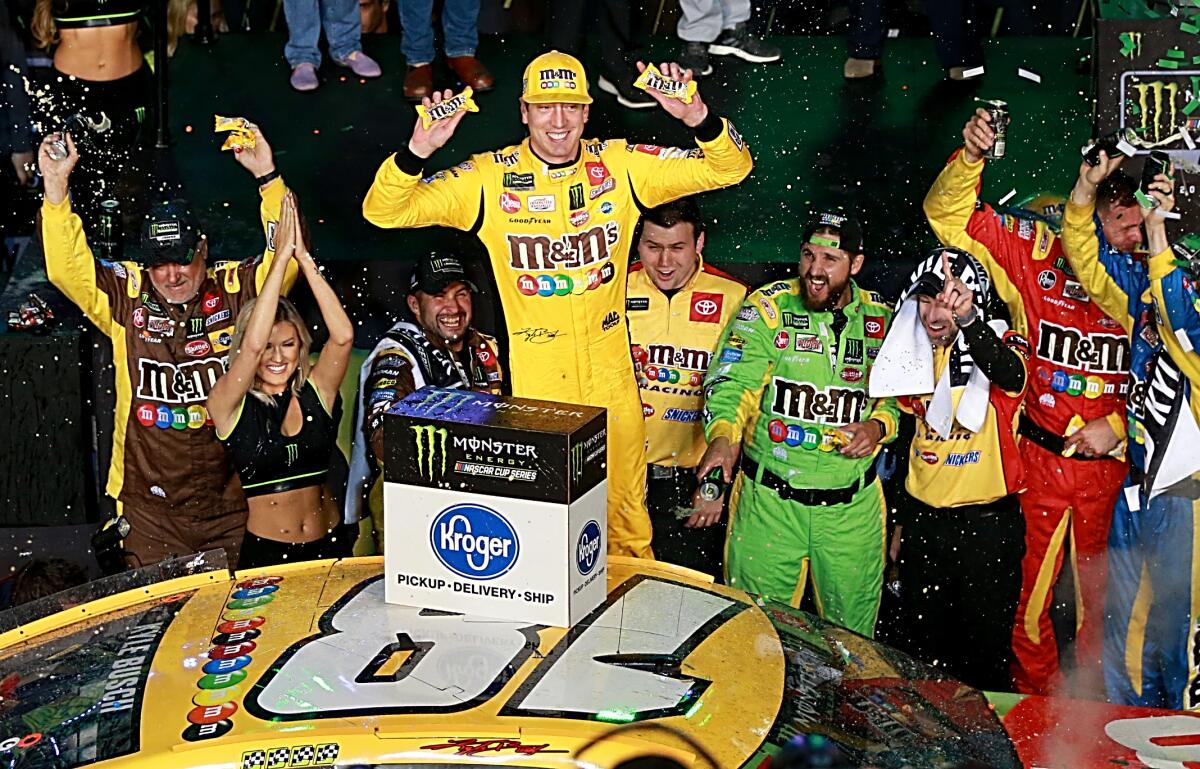 Kyle Busch celebrates after clinching his second NASCAR Cup title Sunday following his win at Homestead Speedway.