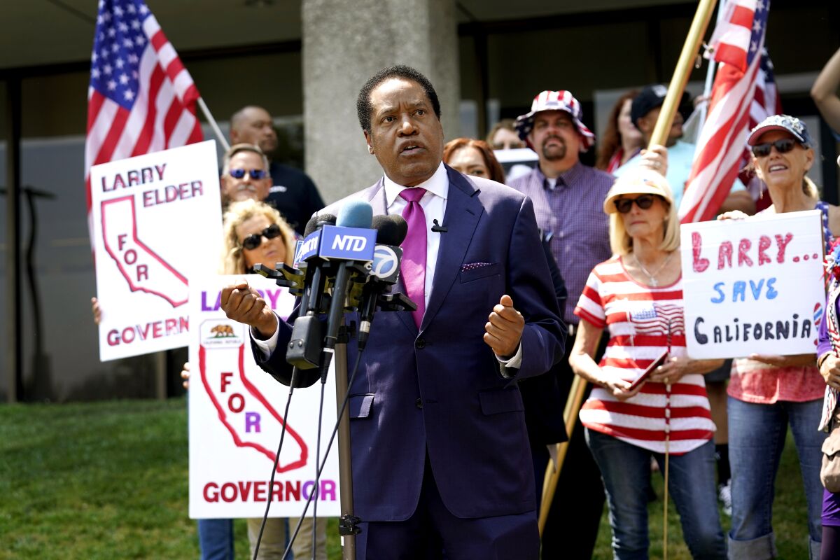 Radio talk-show host Larry Elder speaks to supporters during a campaign stop in Norwalk, Calif., on July 13.