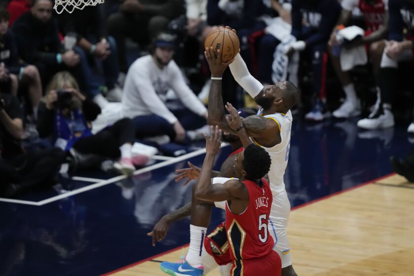 Los Angeles Lakers forward LeBron James (6)goes to the basket against New Orleans Pelicans forward Herbert Jones (5) in the first half of an NBA basketball game in New Orleans, Saturday, Feb. 4, 2023. (AP Photo/Gerald Herbert)