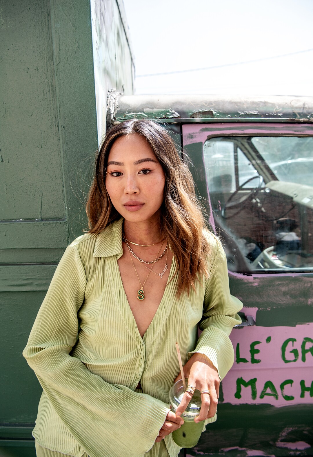 A young woman leans against a truck
