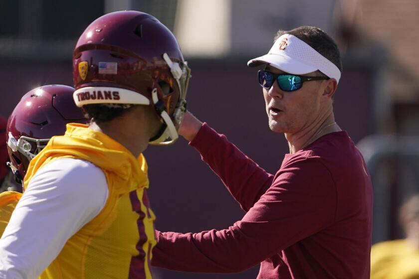 Southern California head coach Lincoln Riley, right, talks with quarterback Caleb Williams during an NCAA college football practice Thursday, March 24, 2022, in Los Angeles. (AP Photo/Mark J. Terrill)