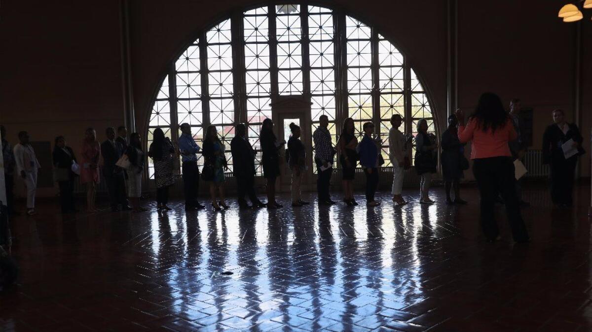 Immigrants arrive at New York's Ellis Island for a naturalization ceremony in September.