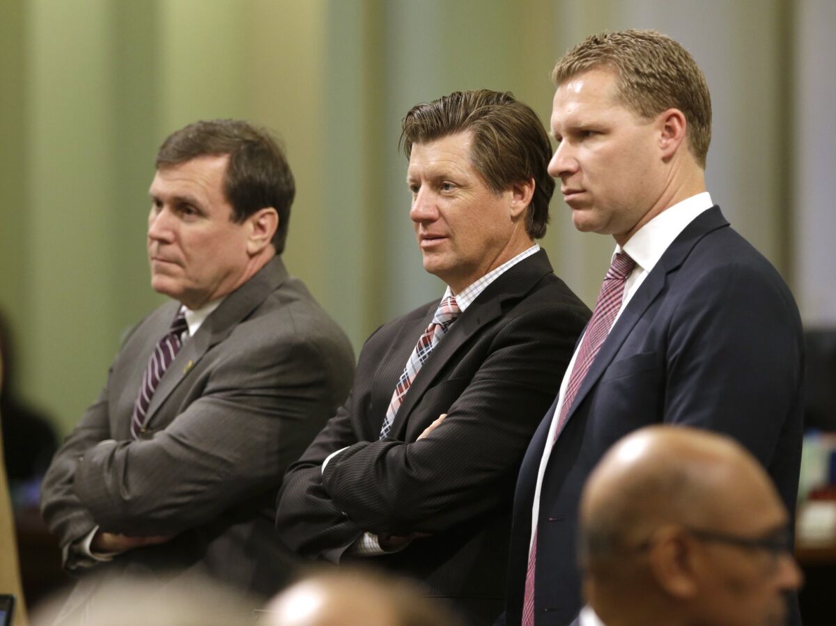 GOP Assemblymen Scott Wilk, left, Brian Jones and Minority Leader Chad Mayes listen during a debate at the Capitol.