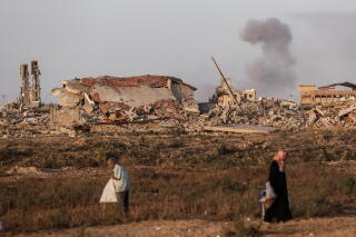 Smoke rises from buildings following heavy Israeli attacks as Palestinians continue to flee northern Gaza toward the south.