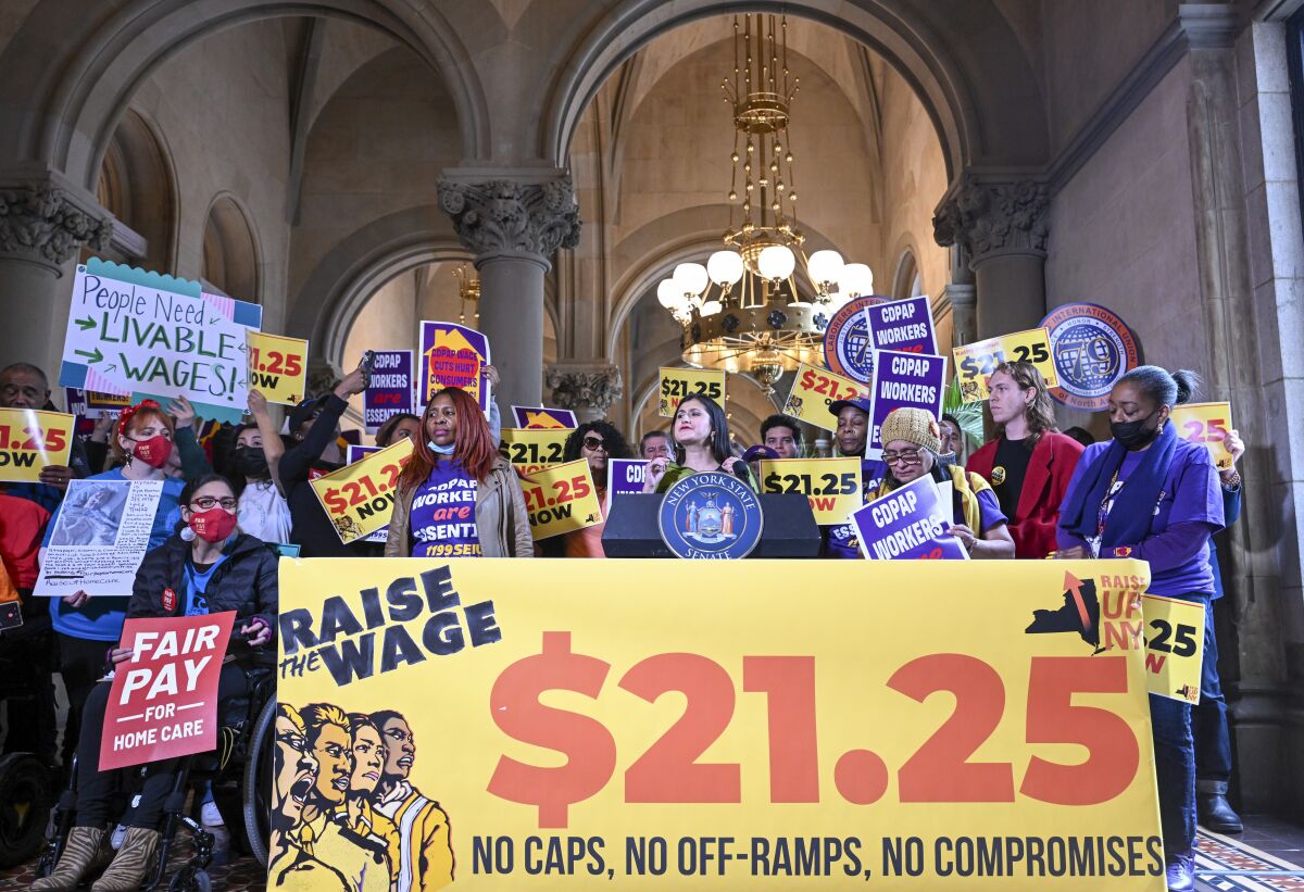 New York Sen. Jessica Ramos, D-East Elmhurst, stands with protesters urging lawmakers to raise New York's minimum wage during a rally at the state Capitol, Monday, March 13, 2023, in Albany, N.Y. (AP Photo/Hans Pennink)