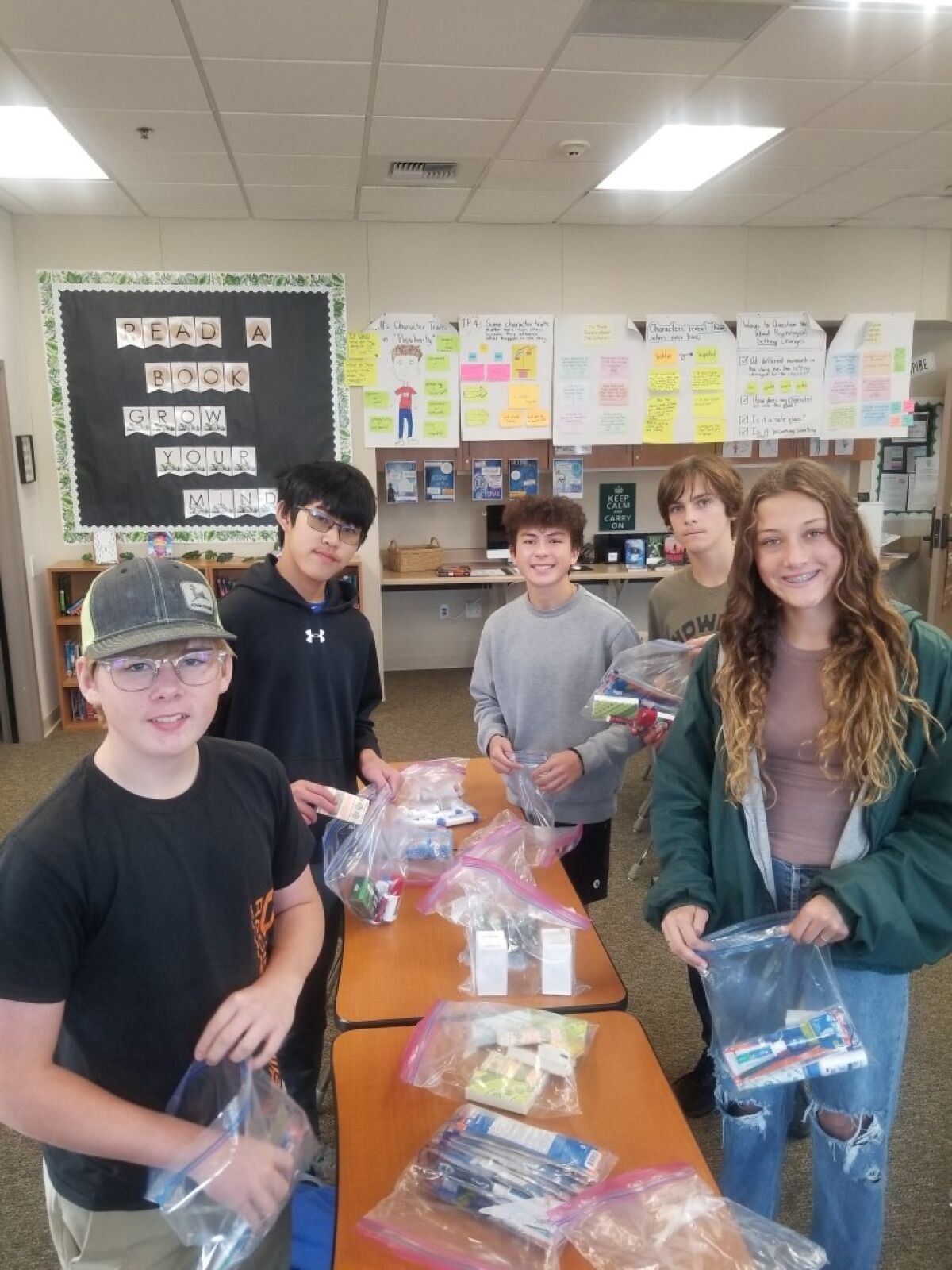 Interactors assembling hygiene bags for San Diego Youth Services.