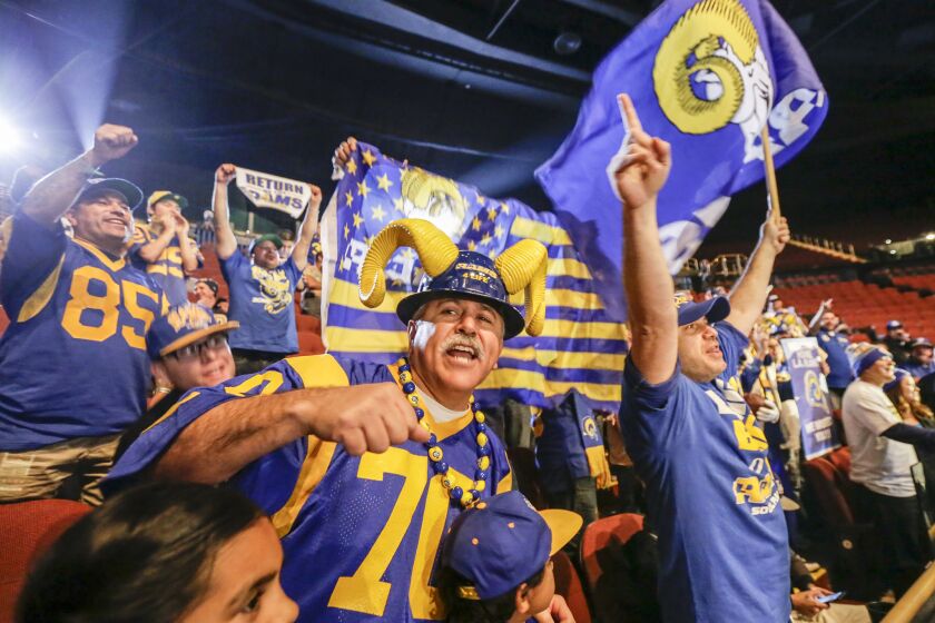 Rams fans at a news conference held by Inglewood Mayor James Butts, Jr. and Los Angeles Rams owner Stan Kroenke at the Forum to celebrate and welcome the team on Jan. 15.