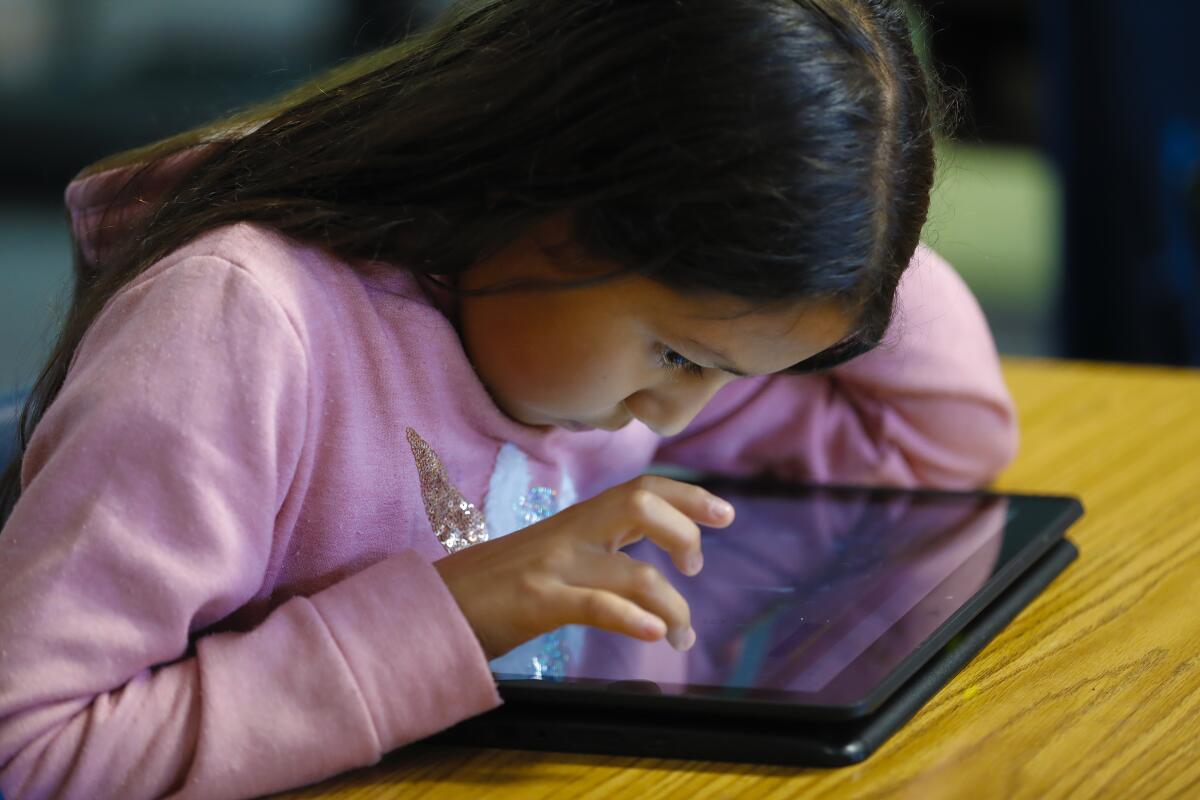 A student uses a laptop to work on a math assignment in February.