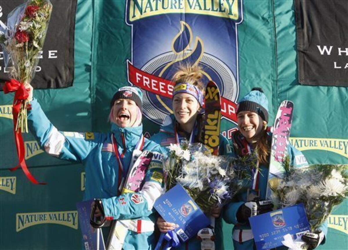 Ladies' moguls winner Hannah Kearney, center, silver-medalist Shannon Bahrke, left, and bronze-medalist Heather McPhie celebrate on the podium during the medals ceremony at the World Cup freestyle skiing event in Wilmington, N.Y., on Thursday, Jan. 21, 2010. (AP Photo/Mike Groll)