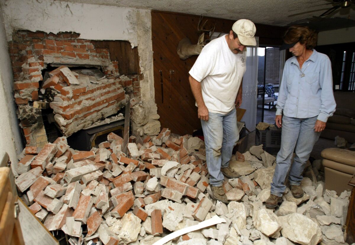 A couple survey the damage to their Parkfield home after a magnitude 6 earthquake hit southern Monterey County in 2004.
