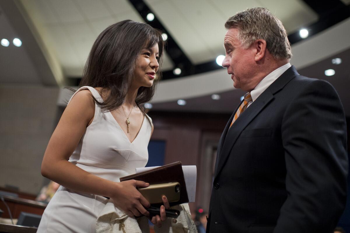 Anastasia Lin, Miss World Canada 2015, talks with Rep. Chris Smith (R -N.J.) before a hearing on China in July.