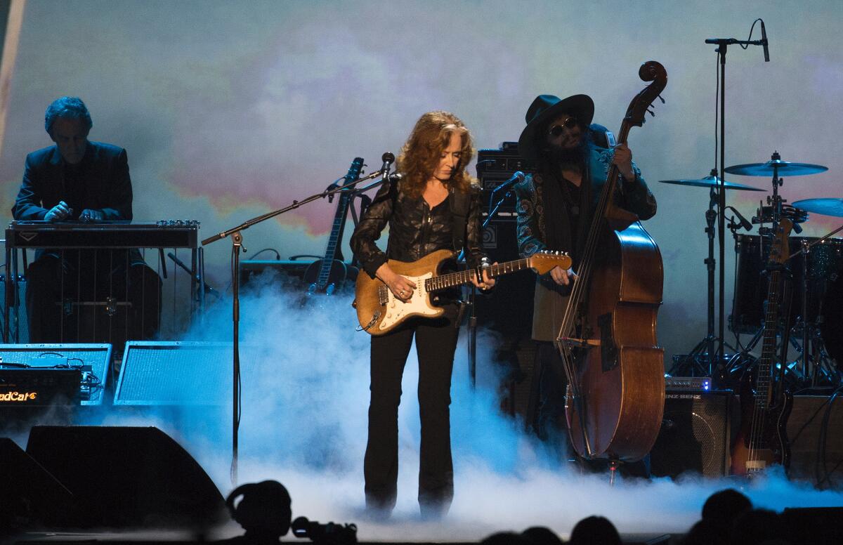 Bonnie Raitt performs during a MusiCares concert honoring Bob Dylan as person of the year at the Los Angeles Convention Center on Friday.