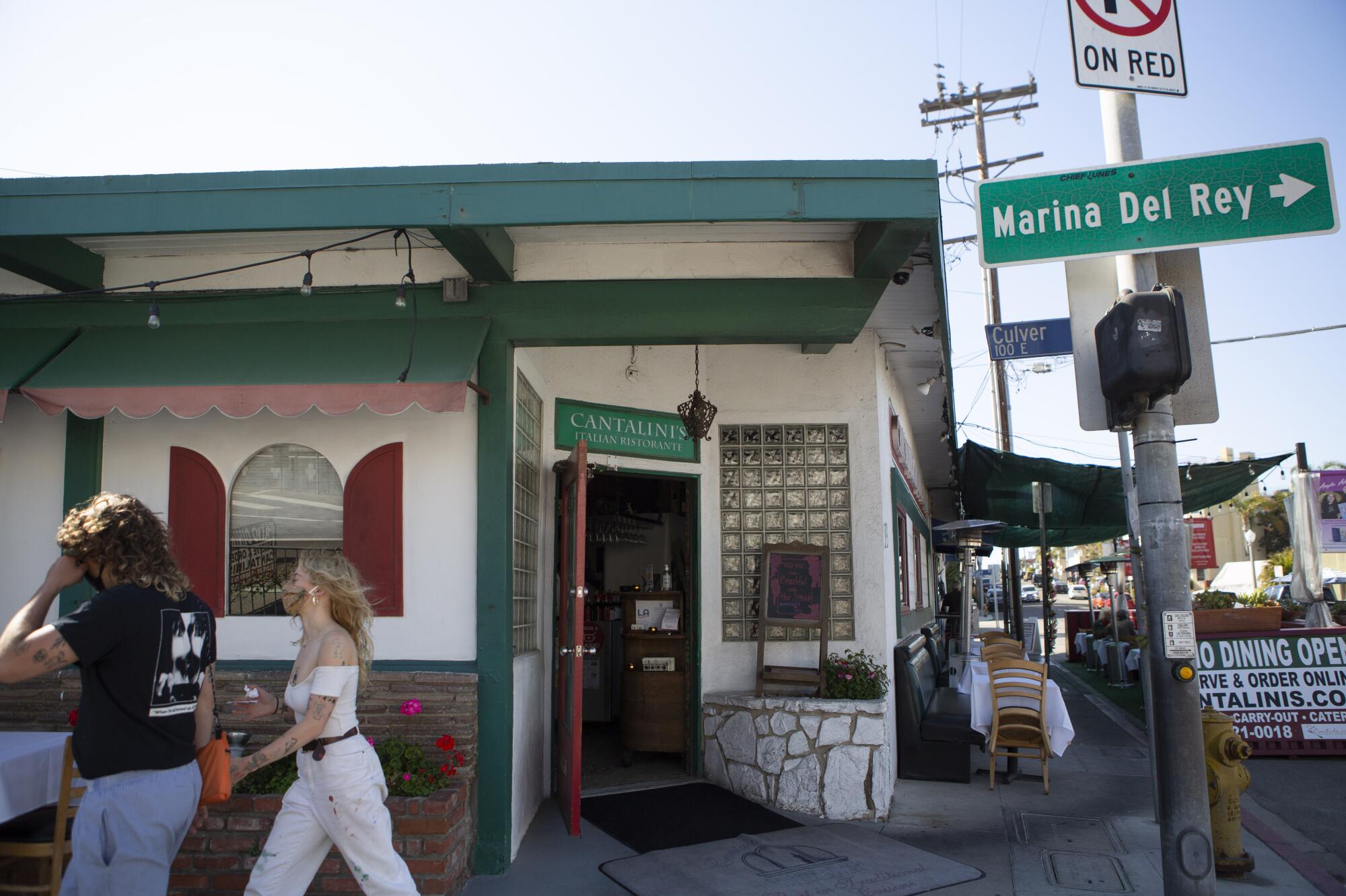 People walk past the exterior of Cantalini's Salerno Beach Restaurant