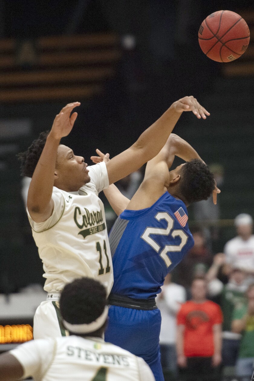 Air Force's Nikc Jackson, right, and Colorado State's Dischon Thomas reach for the ball during an NCAA college basketball game Tuesday, Jan. 4, 2022, at Moby Arena in Fort Collins, Colo. (Jon Austria/The Coloradoan via AP)