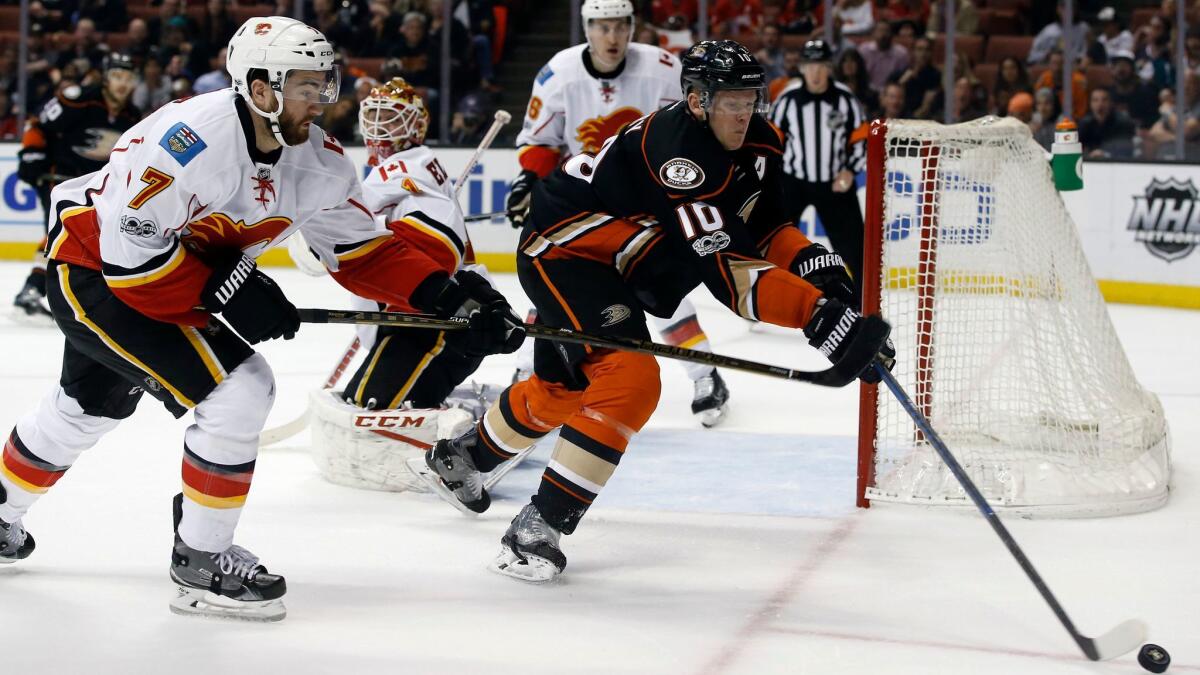 Ducks' Corey Perry looks to control the puck against Calgary's T.J. Brodie on April 4.