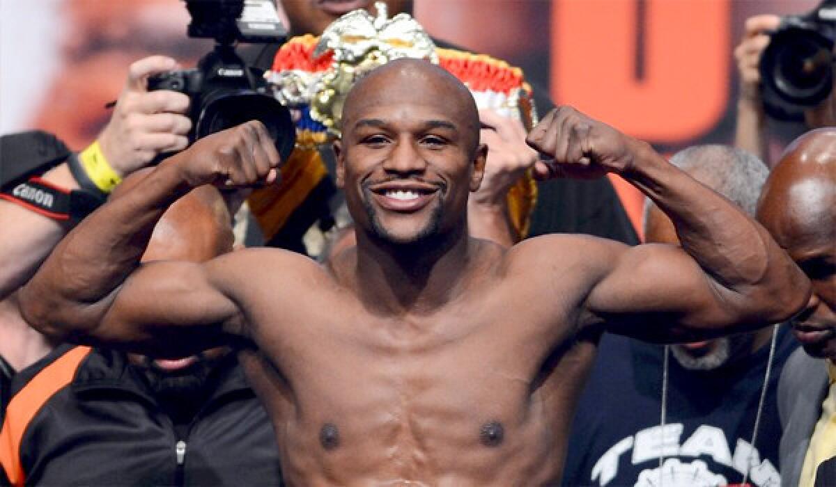 Floyd Mayweather Jr. smiles during the official weigh-in on Sept. 13 before his bout with Saul "Canelo" Alvarez. Mayweather won by decision.