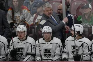 Los Angeles Kings head coach Todd Mcllean gestures during the third period of an NHL hockey game.