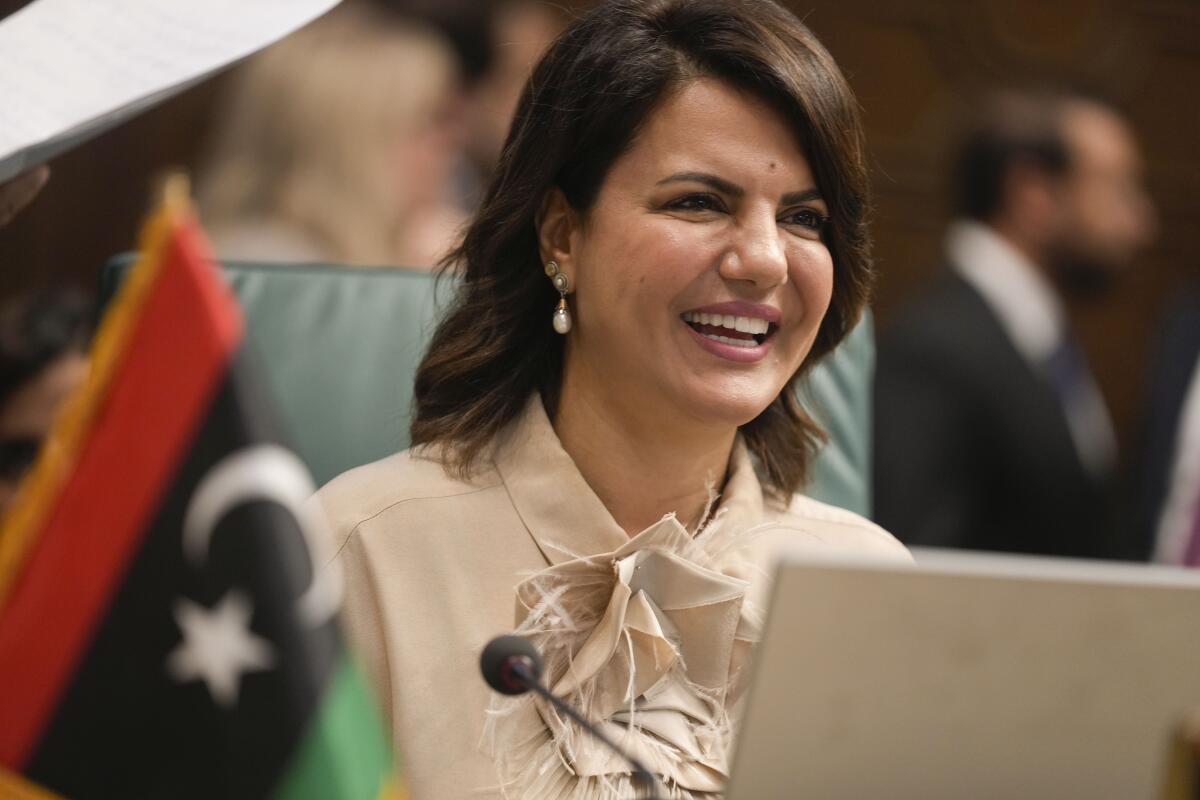 Libyan Foreign Minister Najla Mangoush smiles as she chairs the Arab League foreign ministers annual meeting in Cairo, Egypt, Tuesday, Sept. 6, 2022. (AP Photo/Amr Nabil)